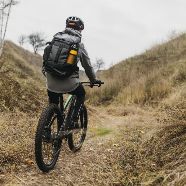 full-shot-man-riding-bike